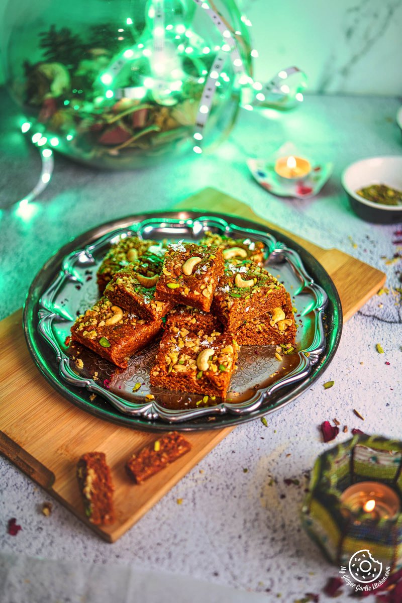 a plate of walnut burfi or akhrot burfi on a table with a green led light in background