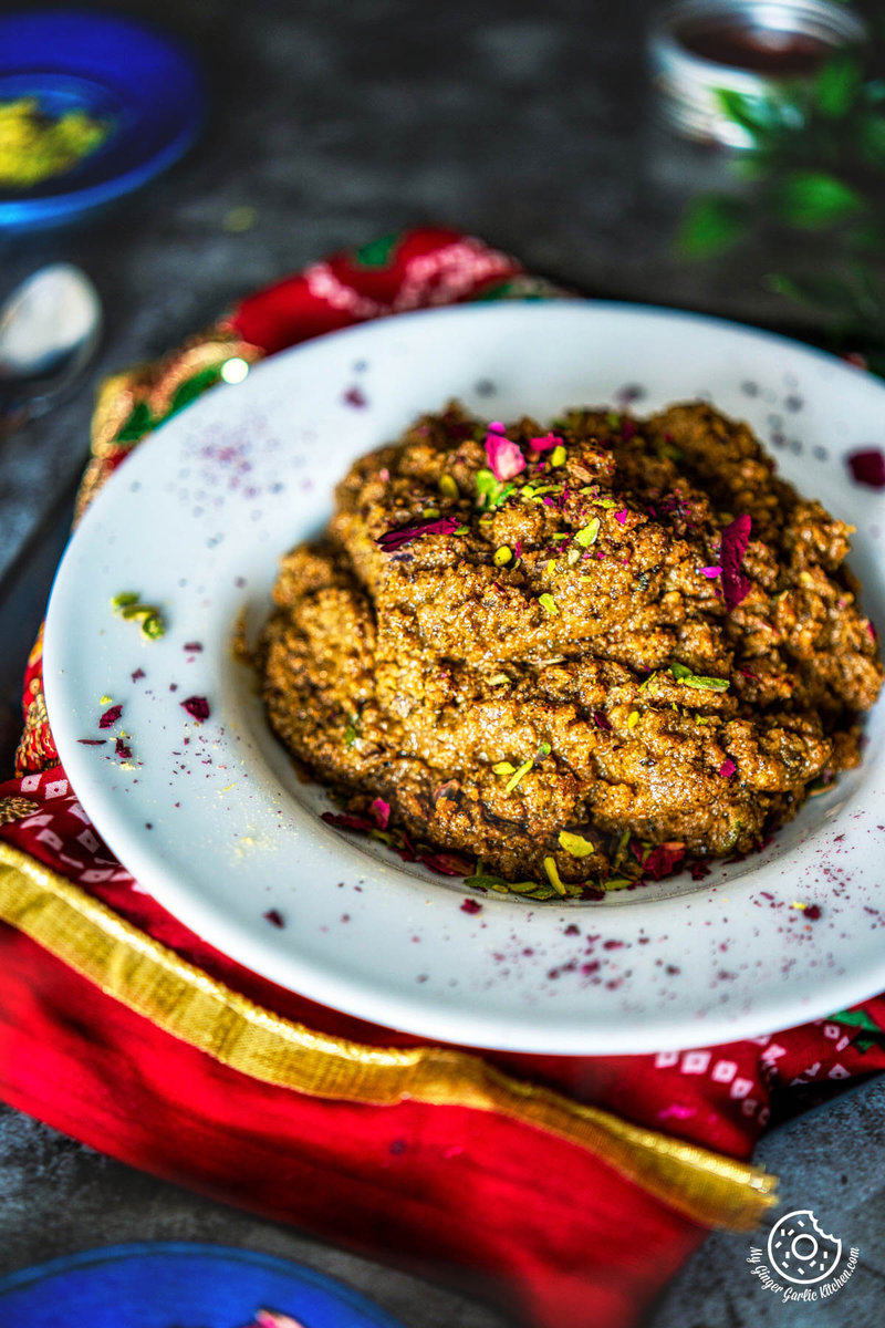 there is a plate of Akhrot Halwa on a table with a red napkin)
