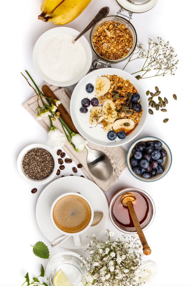 various breakfast dishes and drinks on a table with a white background