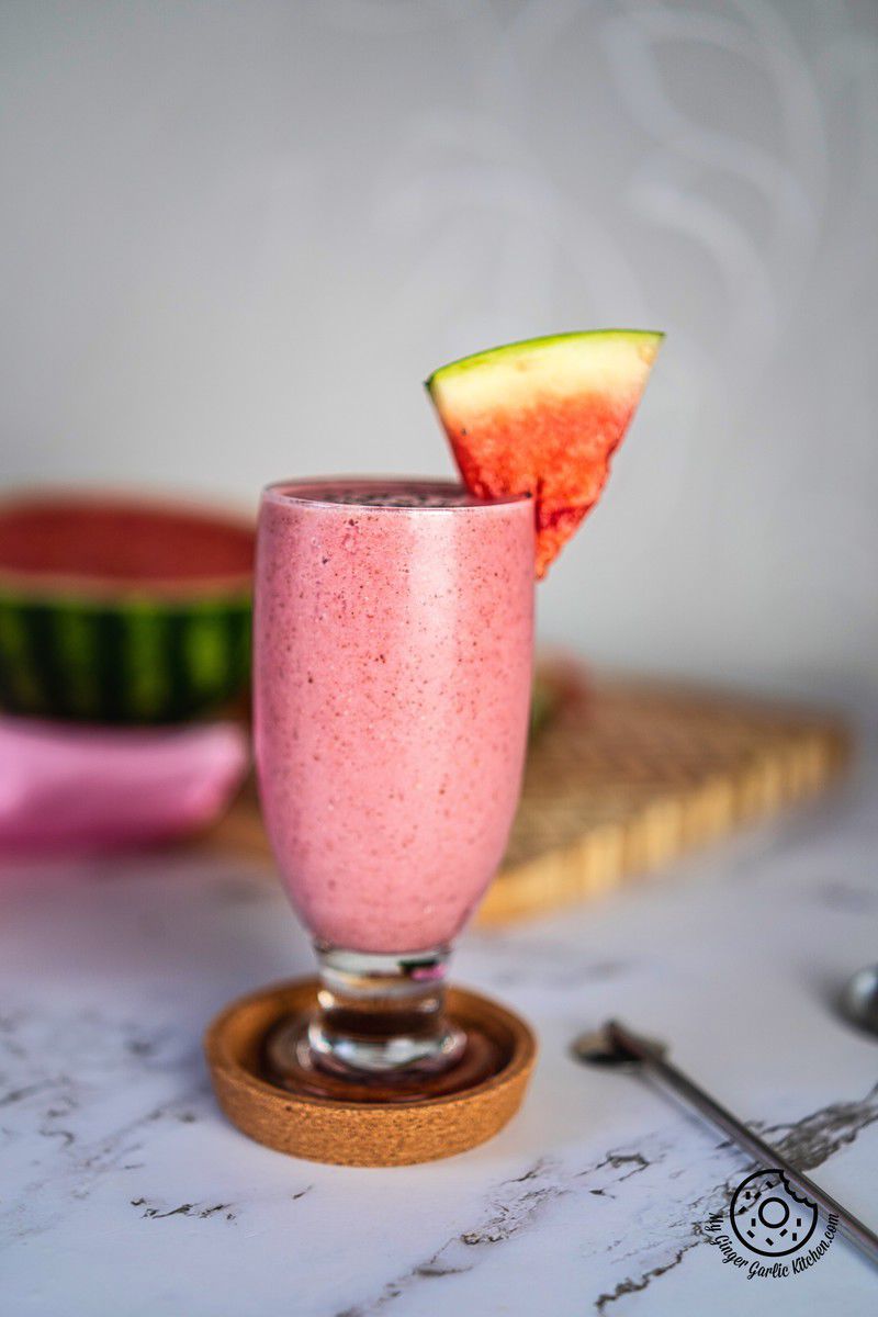 watermelon smoothie in a glass with chia and watermelon slice
