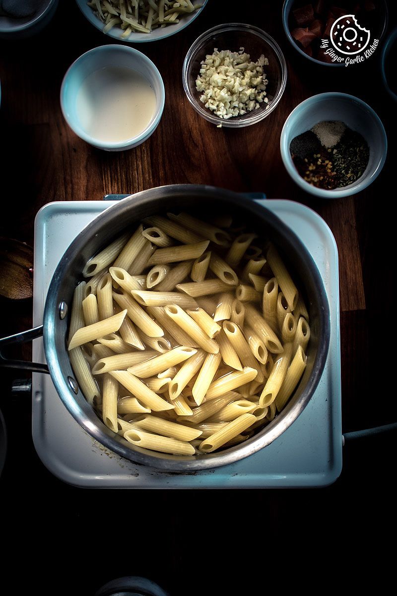 pasta in a pot on a stove with other ingredients