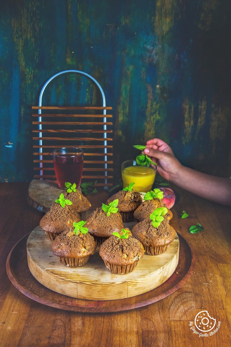whole wheat peach muffins topped with mint leaves